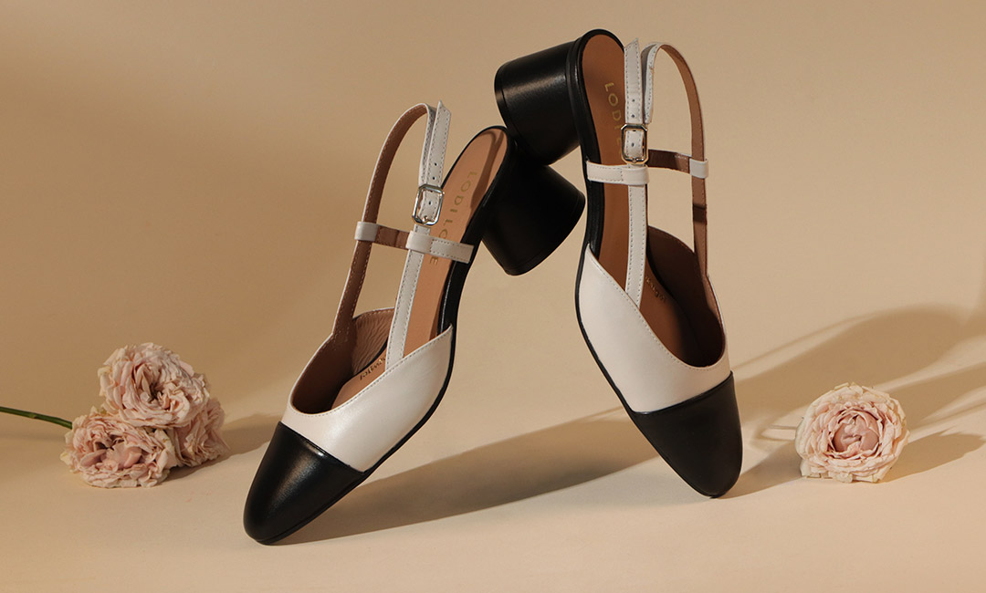 Zapatos de salón blancos y negros con tacón bajo 